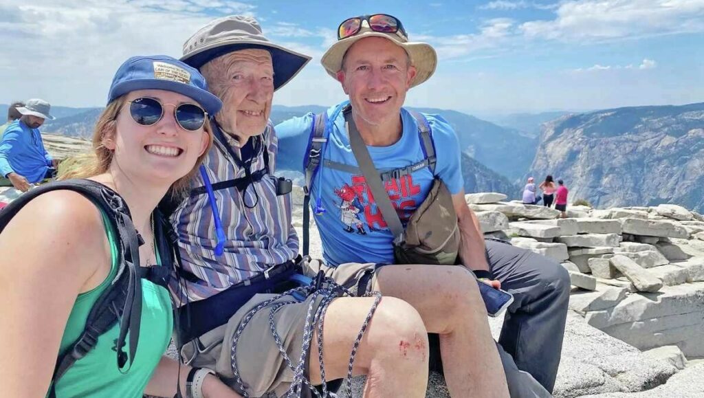 Three people sitting at the top of Yosemite