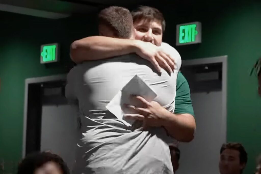 Two football players hugging eachother