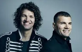 Being named "The Promise" musical performance with two smiling men in military-style jackets.