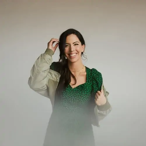 Happy woman smiling, casual style, promoting hope and connection for The Promise project.