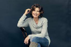 Singer and Song Writer Amy Grant sitting on a chair