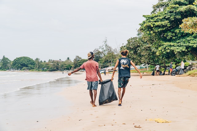People picking up trash on a beach